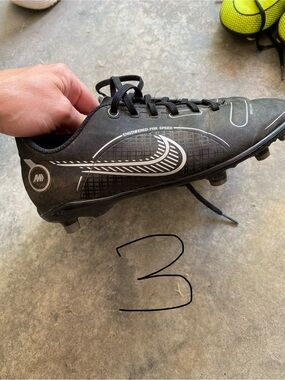 Nike Black youth Soccer Cleats with White Swoosh